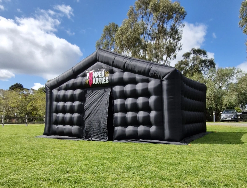 The black inflatable party room in a backyard
