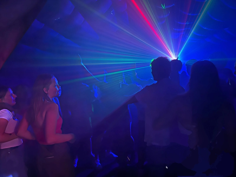 Guests enjoying lights and music inside the tent