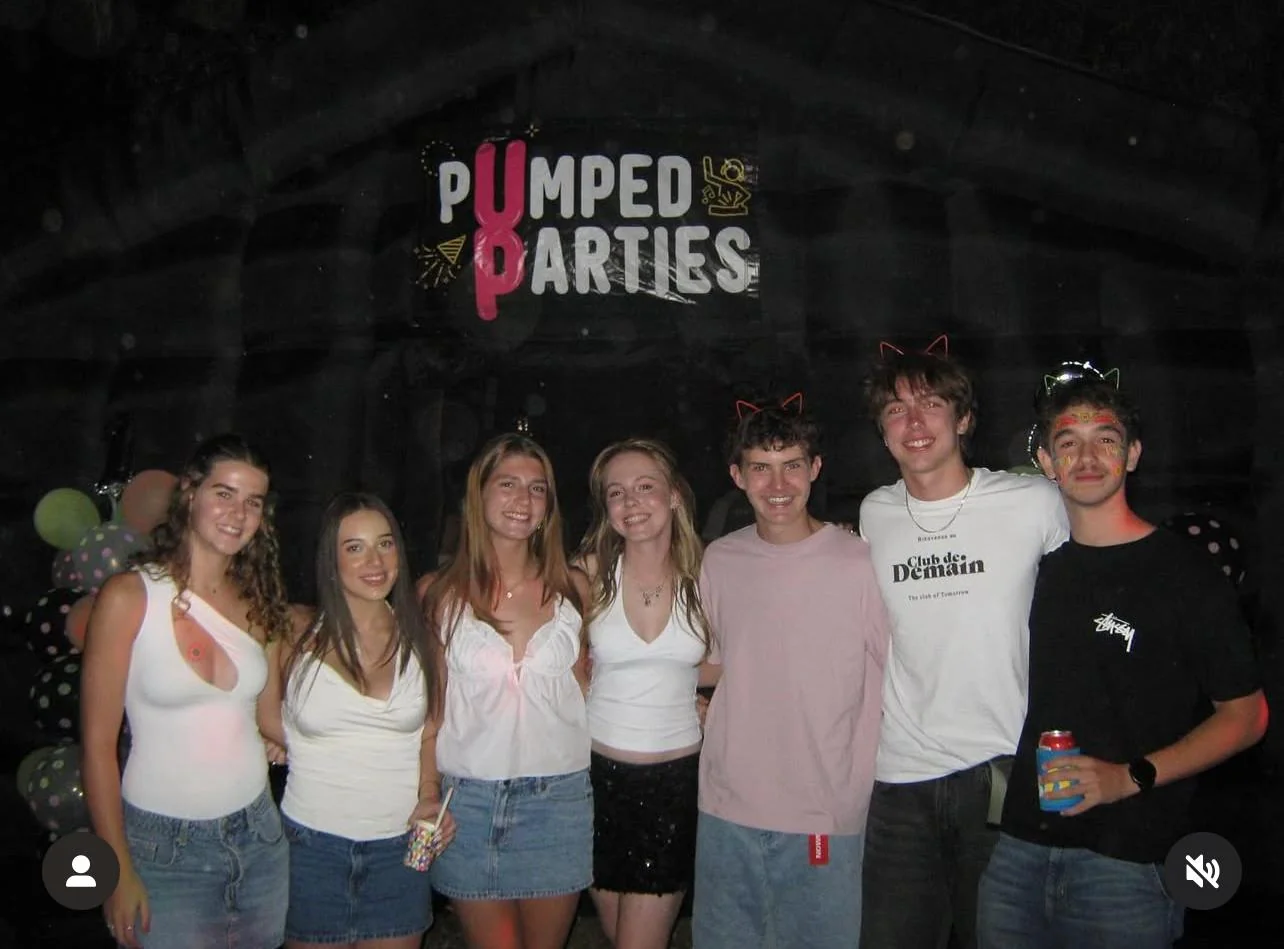 Friends celebrating inside the black inflatable nightclub
