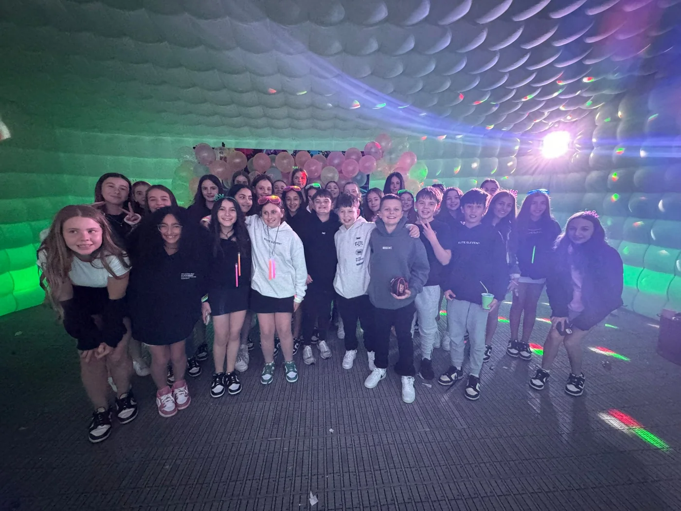 Birthday guests inside the white inflatable party tent